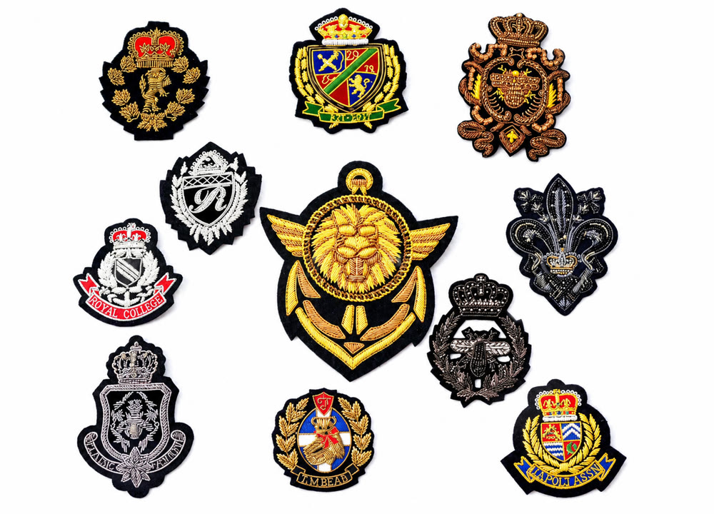 Factory samples of hand-embroidered gold and silver bullion wire badges