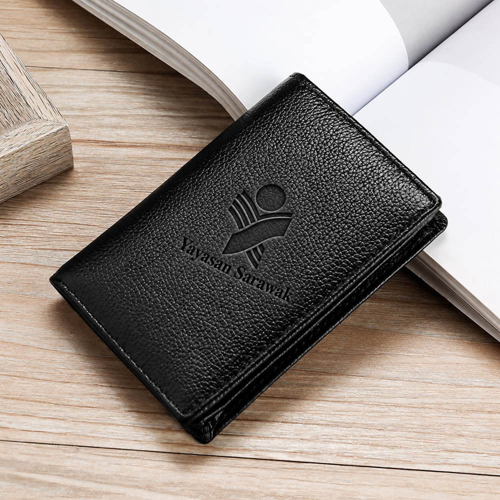 Black leather card holder with the Yayasan Sarawak logo debossed