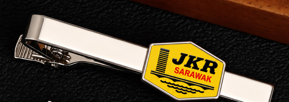 Silver tie bar with a hexagon enamel plate cut to the JKR Sarawak logo